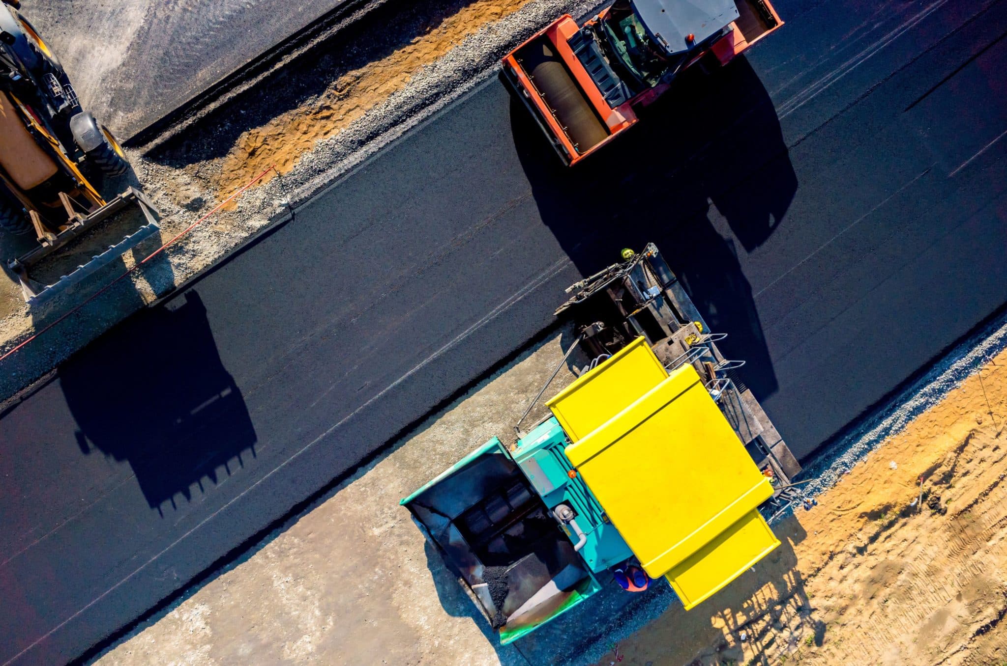 a yellow and blue truck driving down a road