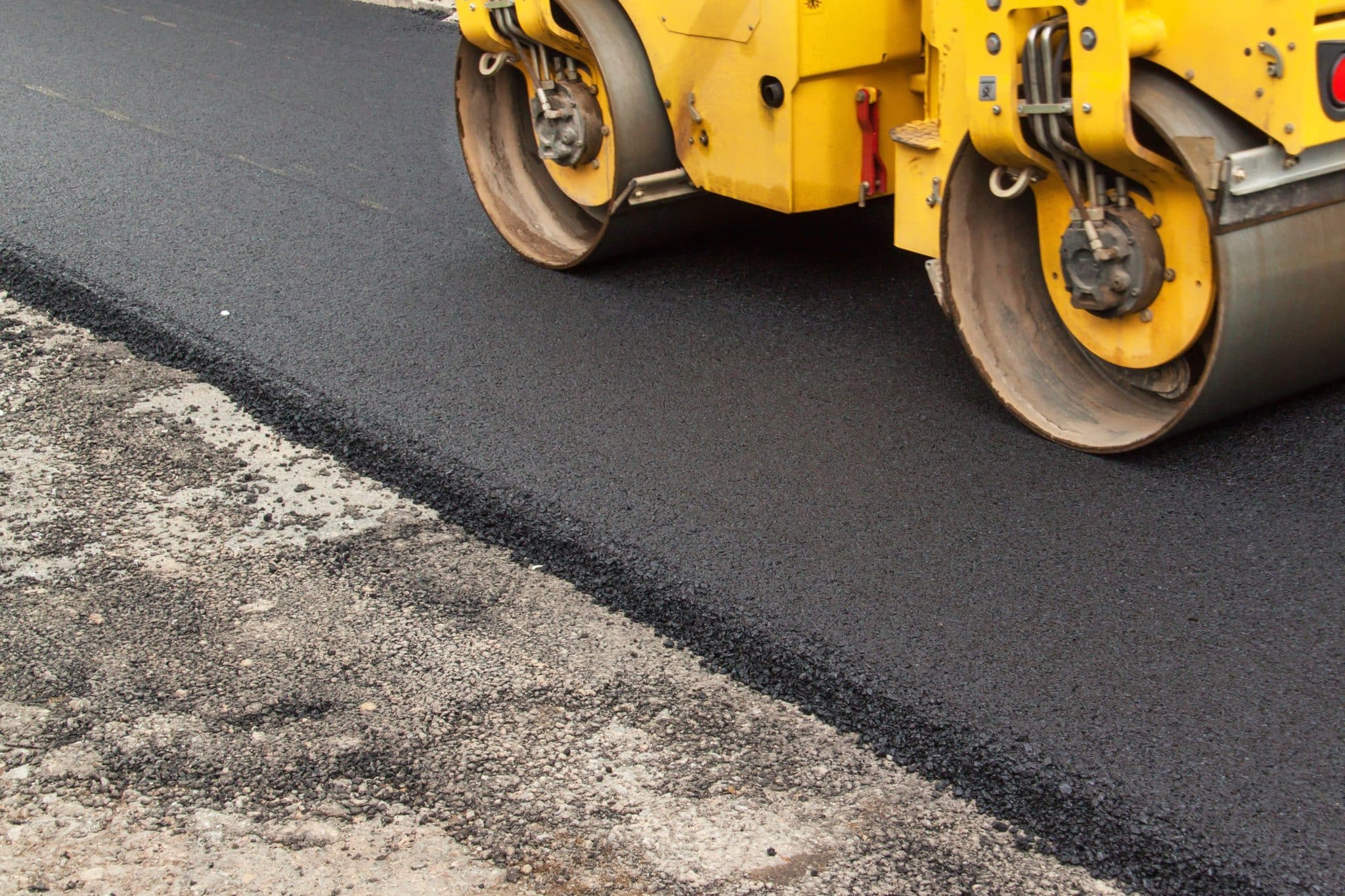 a yellow machine is driving down the road