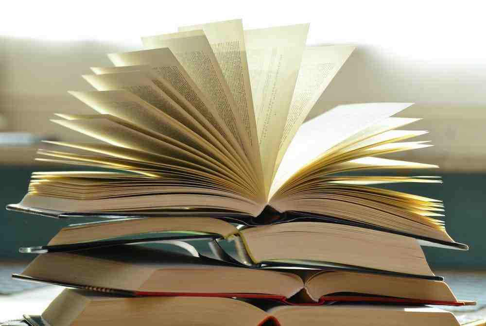 a stack of books sitting on top of a table