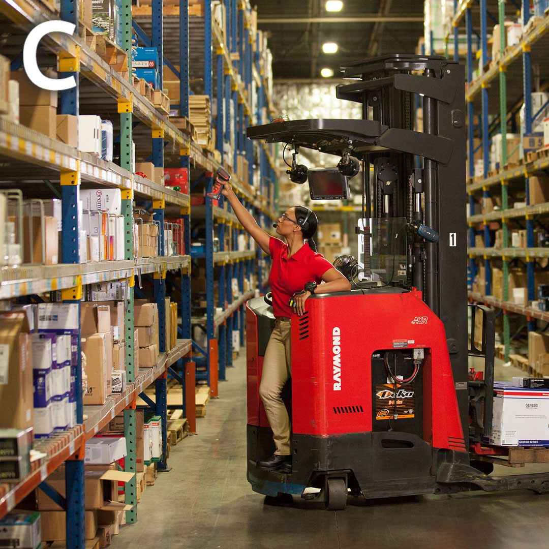 a man in a red shirt is on a forklift