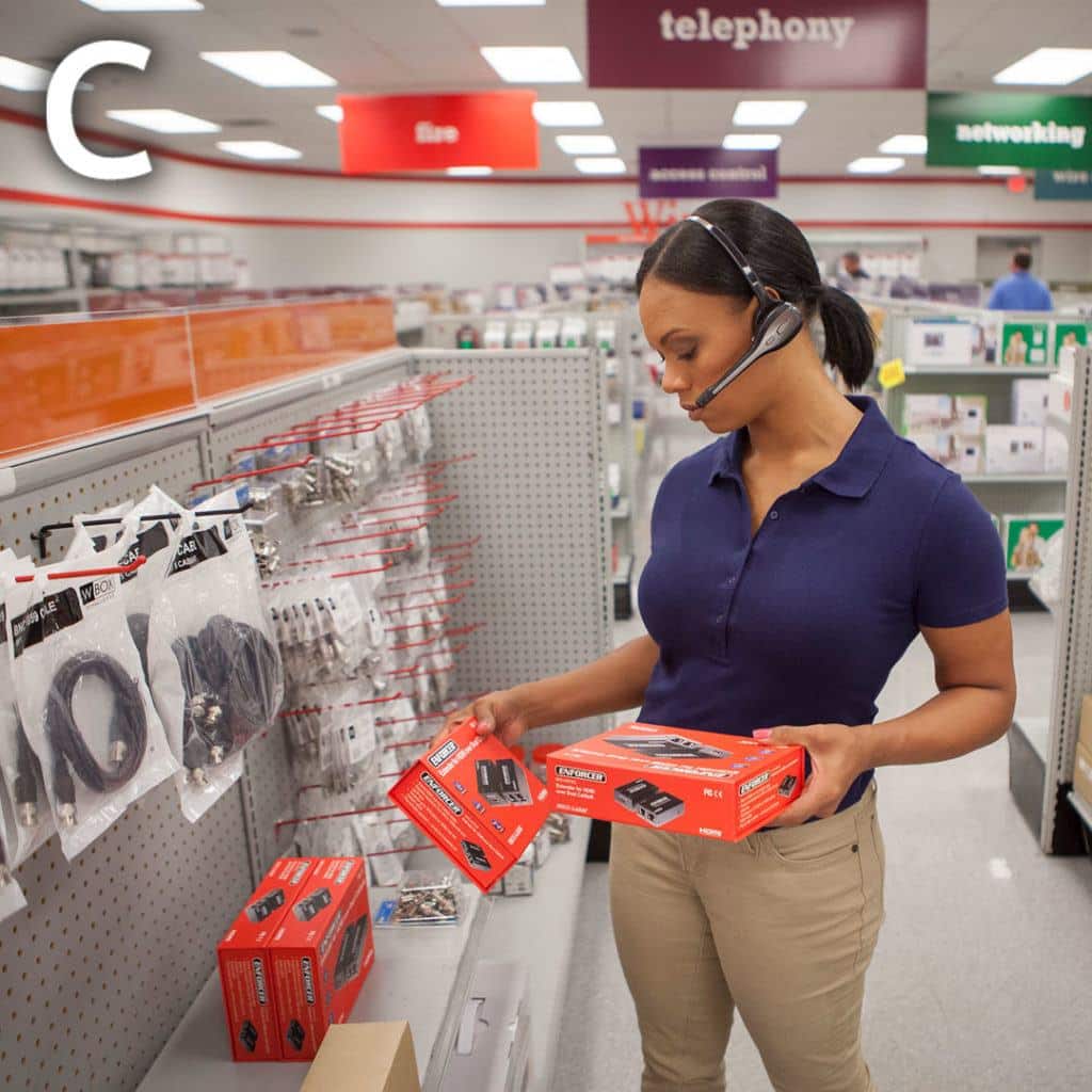 a woman wearing a headset is looking at some electronics