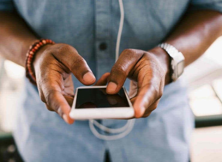 a man holding a smart phone in his hands