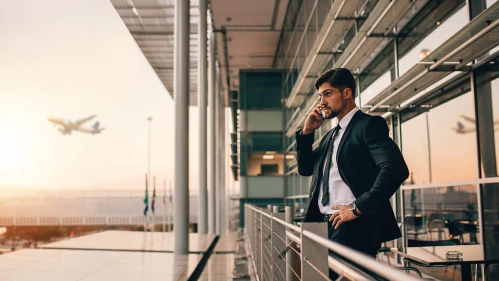 a man in a suit talking on a cell phone