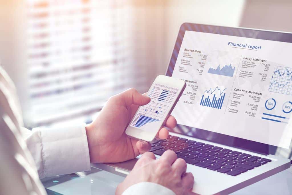 Accountant working on consolidated financial report of corporate operations, consultant auditing finance data (balance sheet, income statement) on screen with business charts, fintech, manager