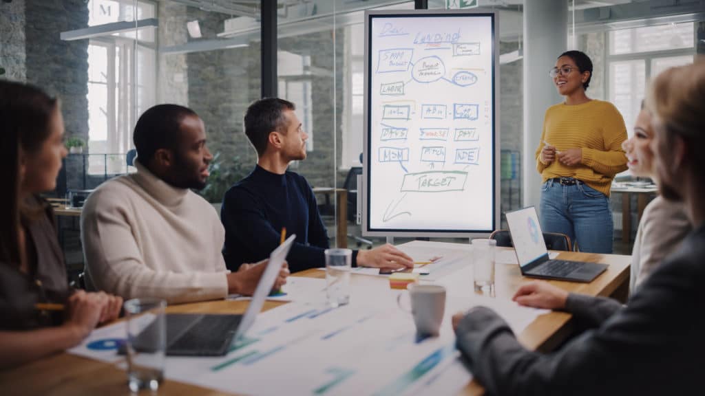 Why Erp Projects Fail: The Real Reasons Behind Delays, Budget Overruns, And Weak Adoption 3 a group of people sitting around a table with laptops