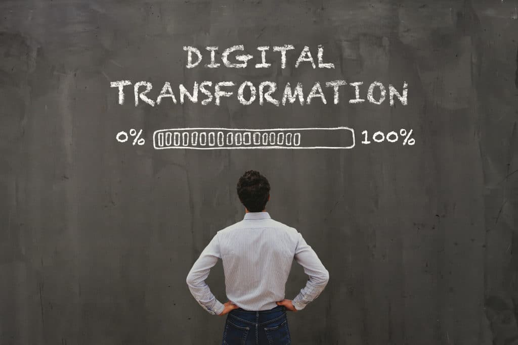 a man standing in front of a chalkboard with the words digital information written on it