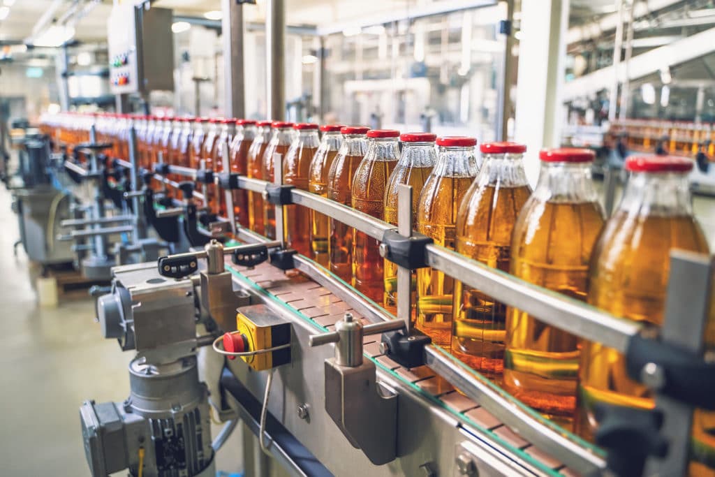 a factory filled with lots of bottles of liquid