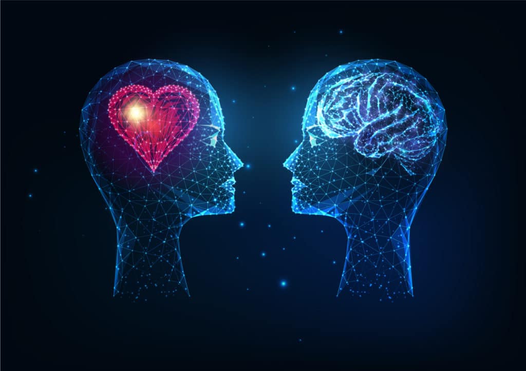two human heads facing each other with a glowing heart in the middle