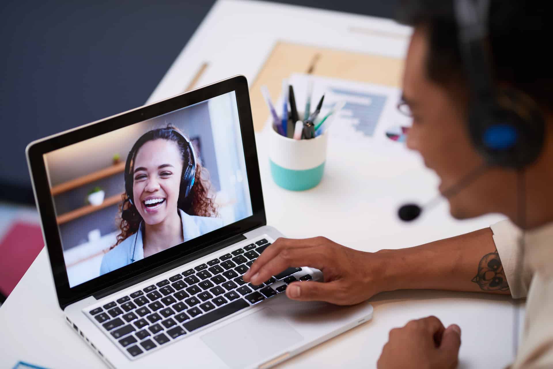 a man with headphones on is using a laptop