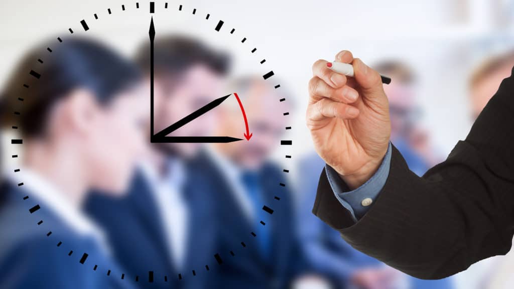 a person drawing on a clock with a marker