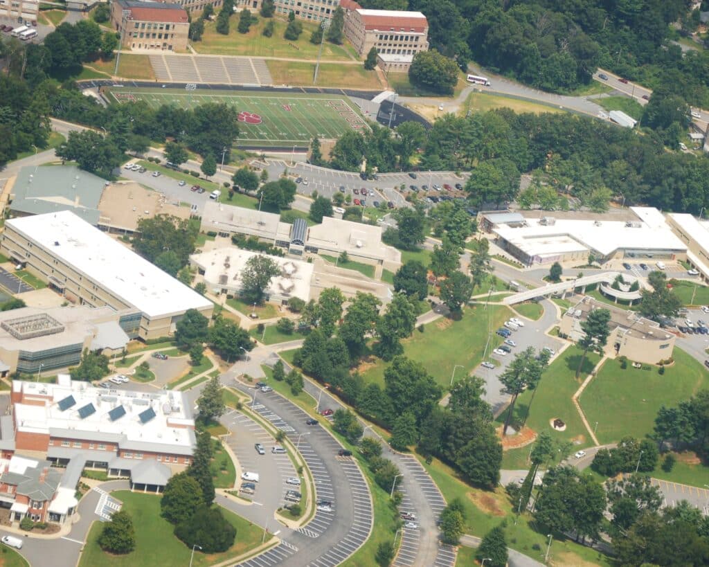 an aerial view of a school campus and parking lot