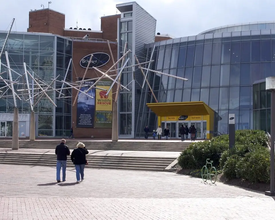 two people are walking in front of a building