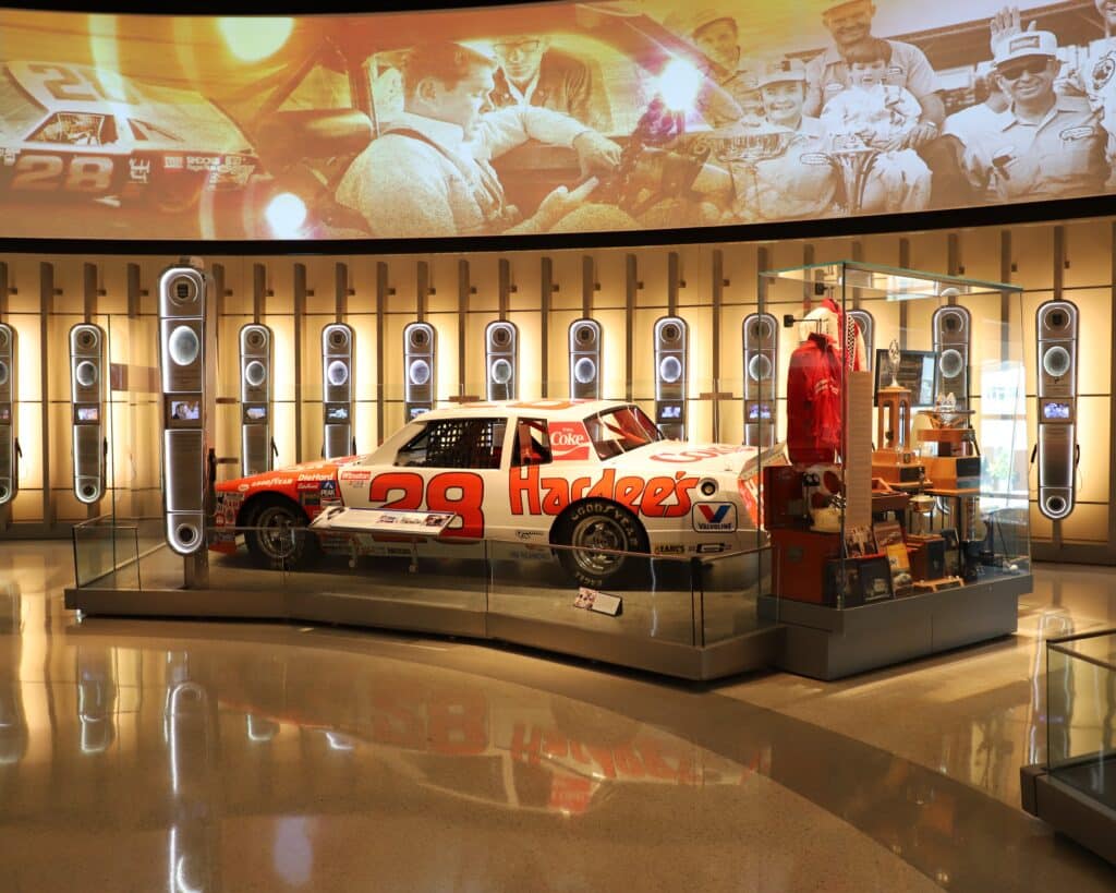 a display case filled with cars and other items