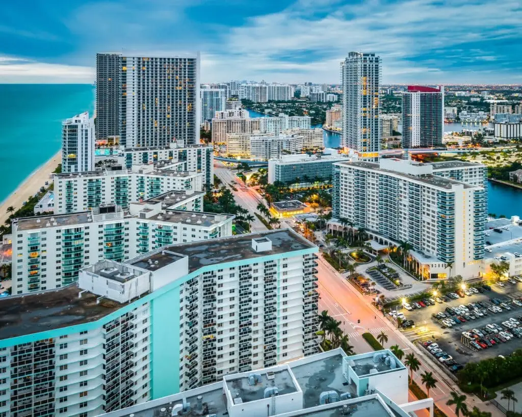 a city with lots of tall buildings next to the ocean