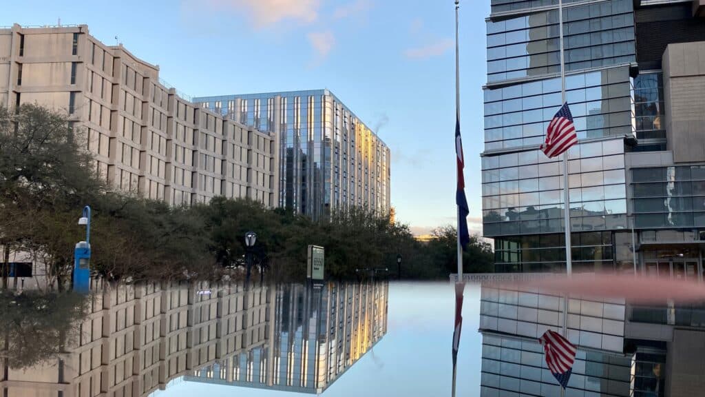 the reflection of buildings in the water is shown