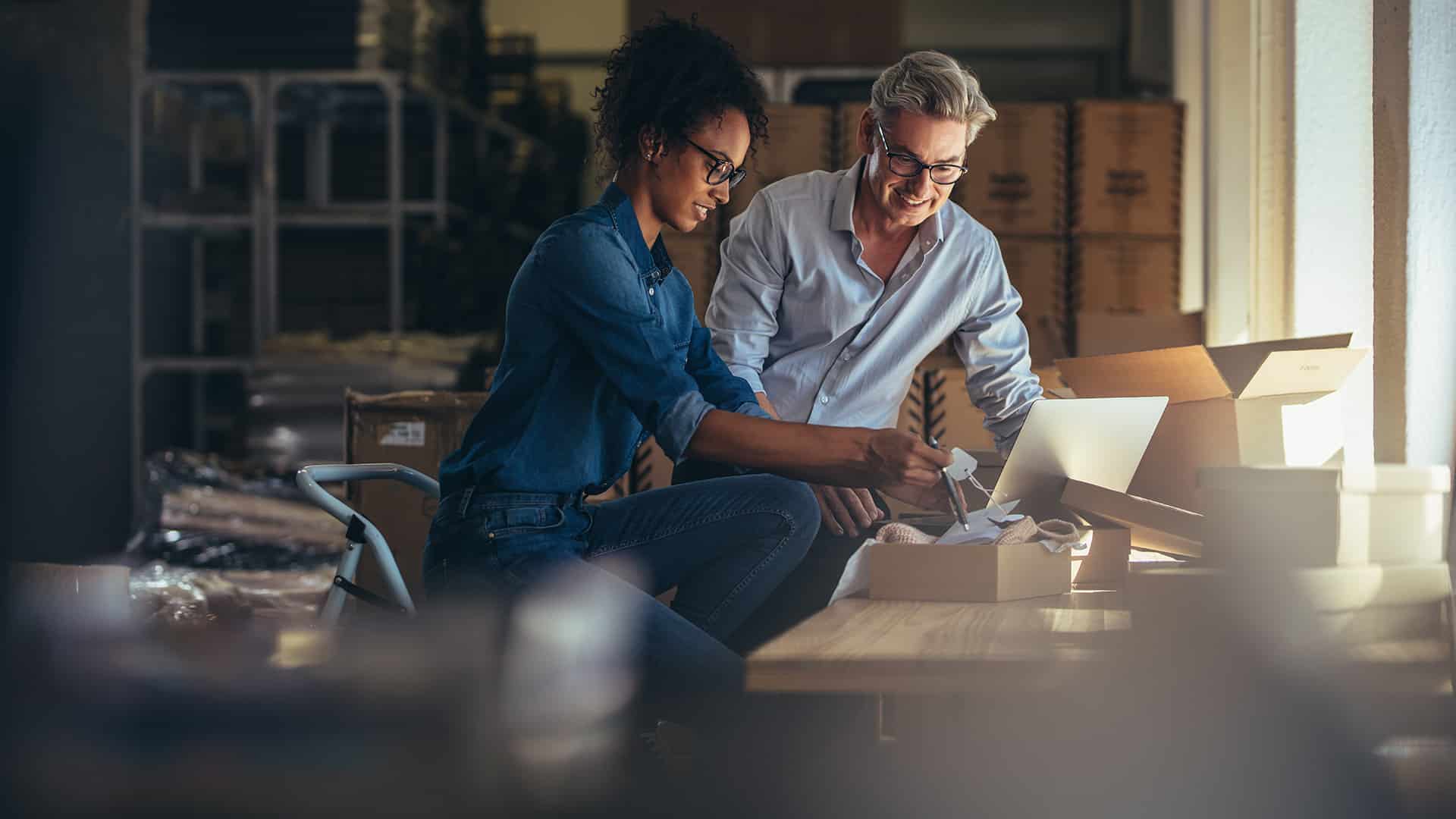 a man and woman are looking at something on a table