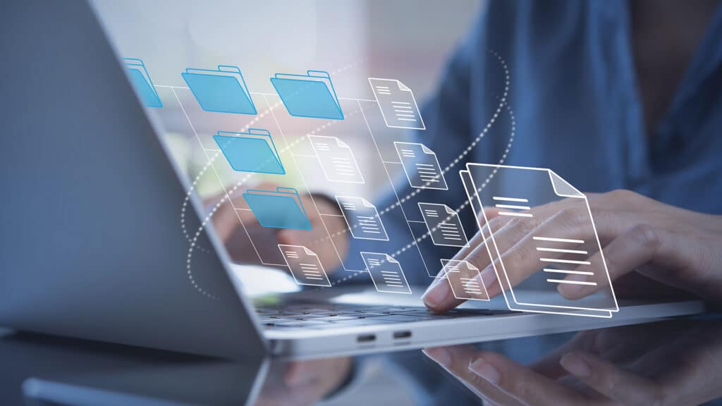 a person using a laptop computer with icons coming out of it