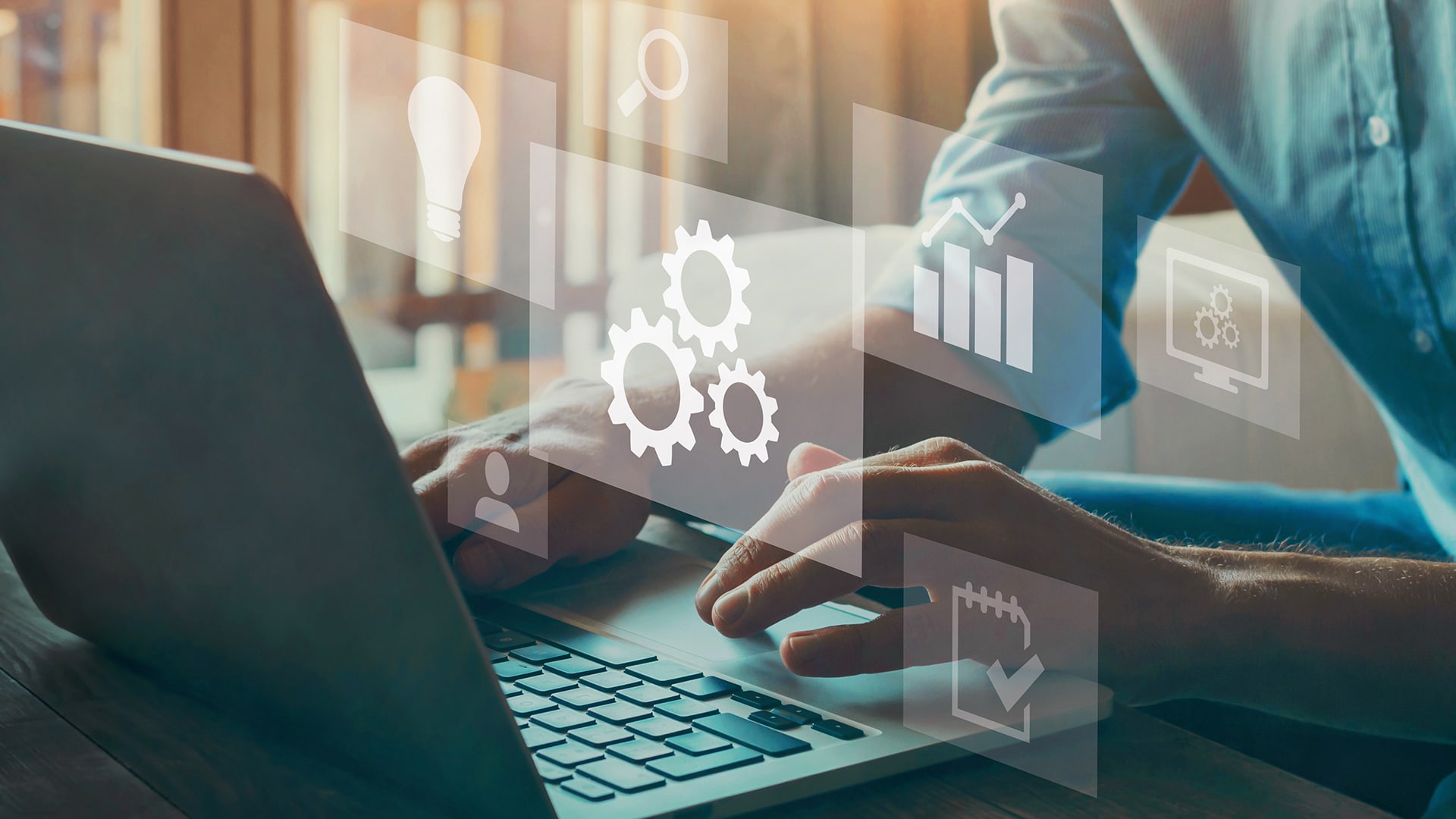 a person using a laptop with icons coming out of it