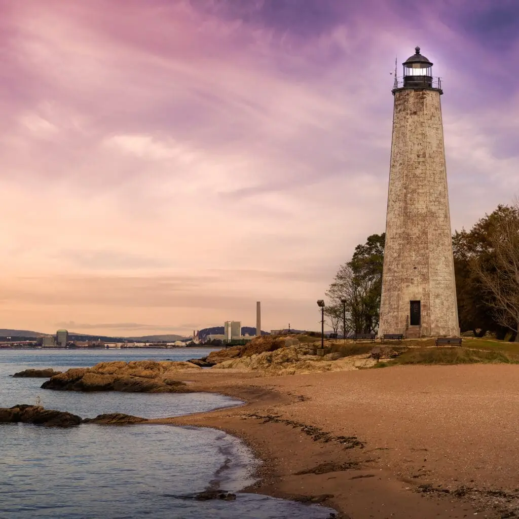 a light house sitting on top of a sandy beach