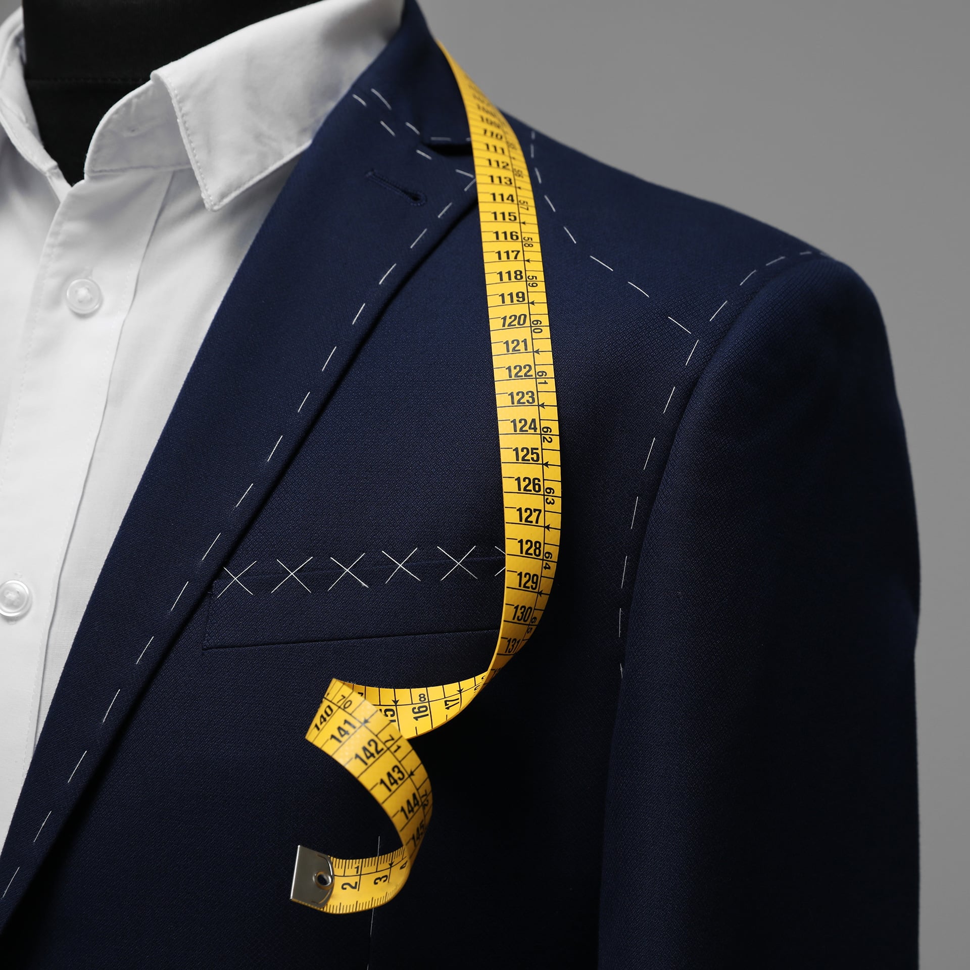 a suit with a yellow measuring tape on it