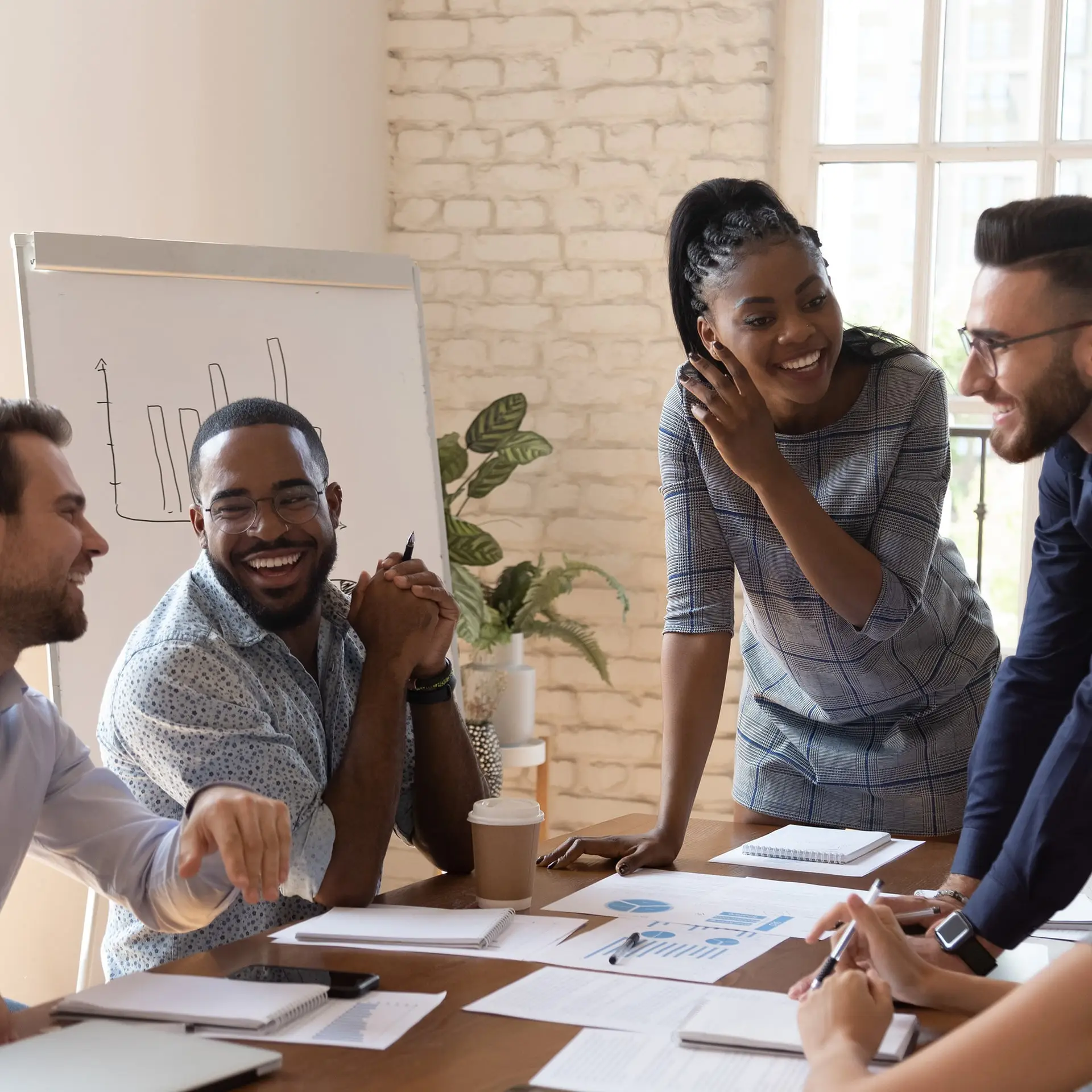 a group of people sitting around a wooden table