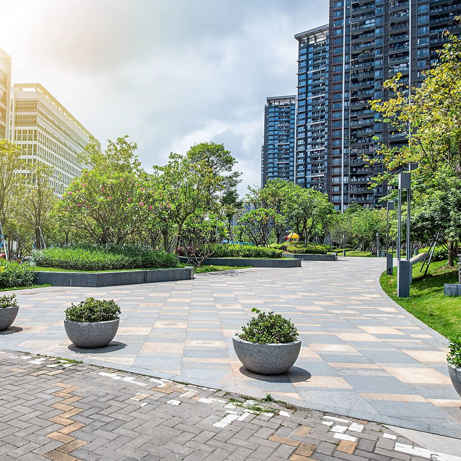 three planters are sitting in the middle of a courtyard