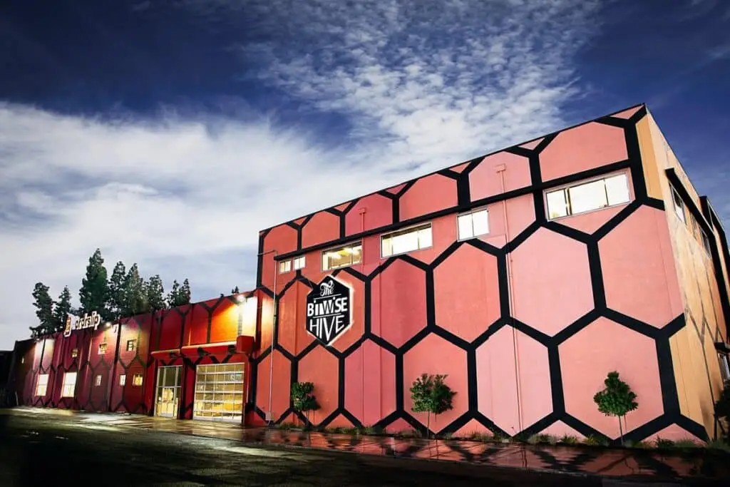 a pink building with a street sign on it
