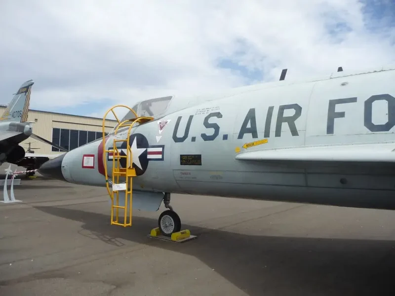 an air force jet sitting on top of an airport tarmac