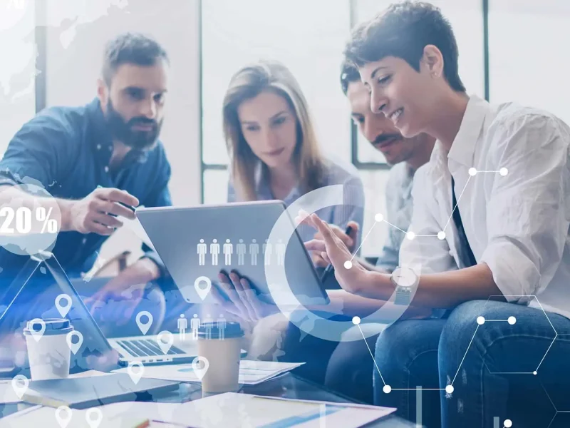 three people looking at a tablet in front of them