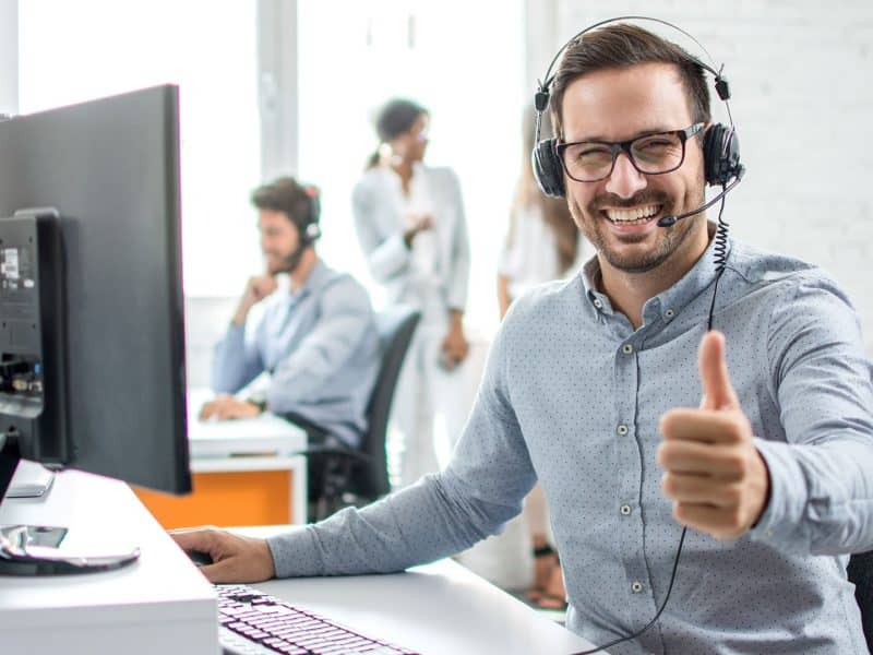 a man wearing headphones giving a thumbs up
