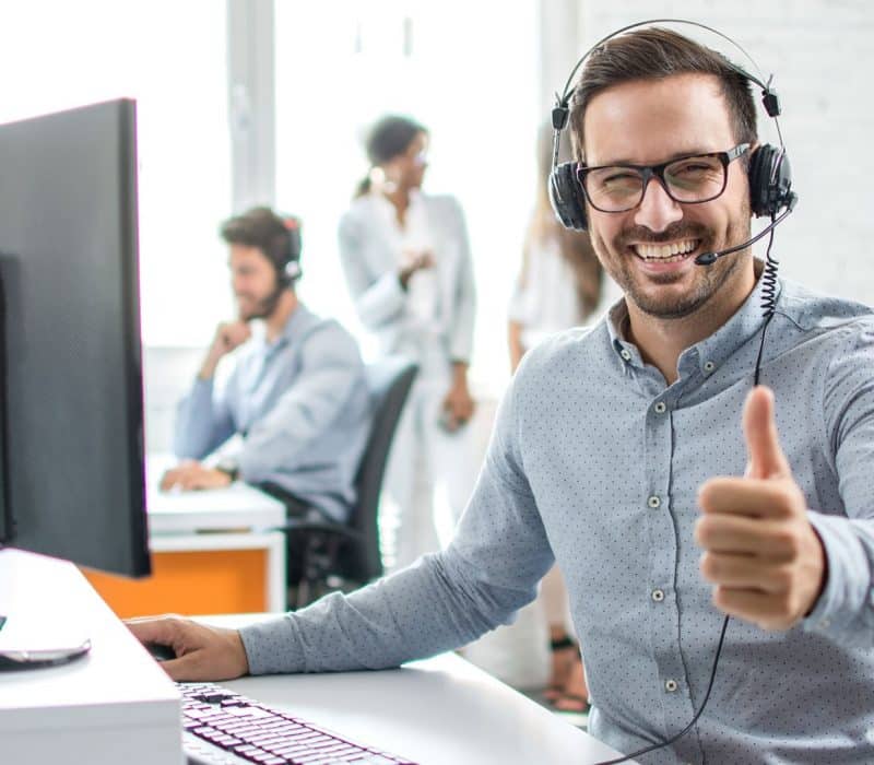 a man wearing headphones giving a thumbs up