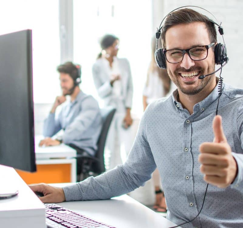 a man wearing headphones giving a thumbs up