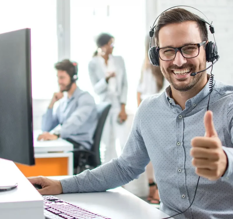 a man wearing headphones giving a thumbs up