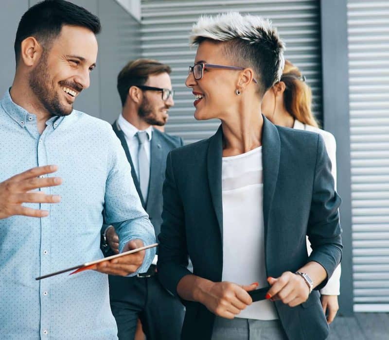 two men and a woman are talking to each other